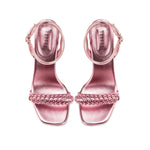 Elegant metallic pink ankle cross sandals with braided front strap and stiletto heel, perfect for evening wear.