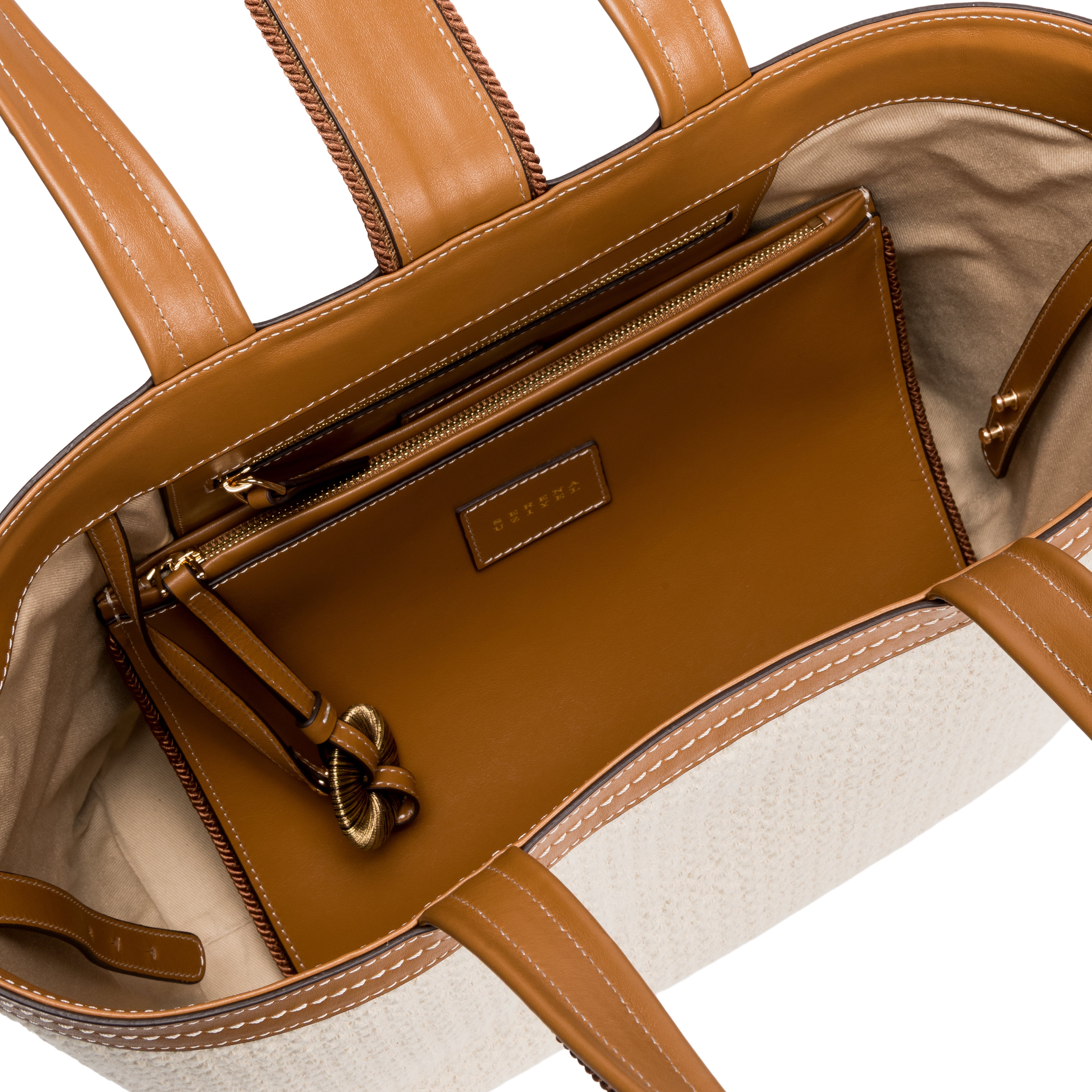 Inside view of a Boho Chic medium off white tote bag, featuring a brown zippered pouch and spacious compartment.