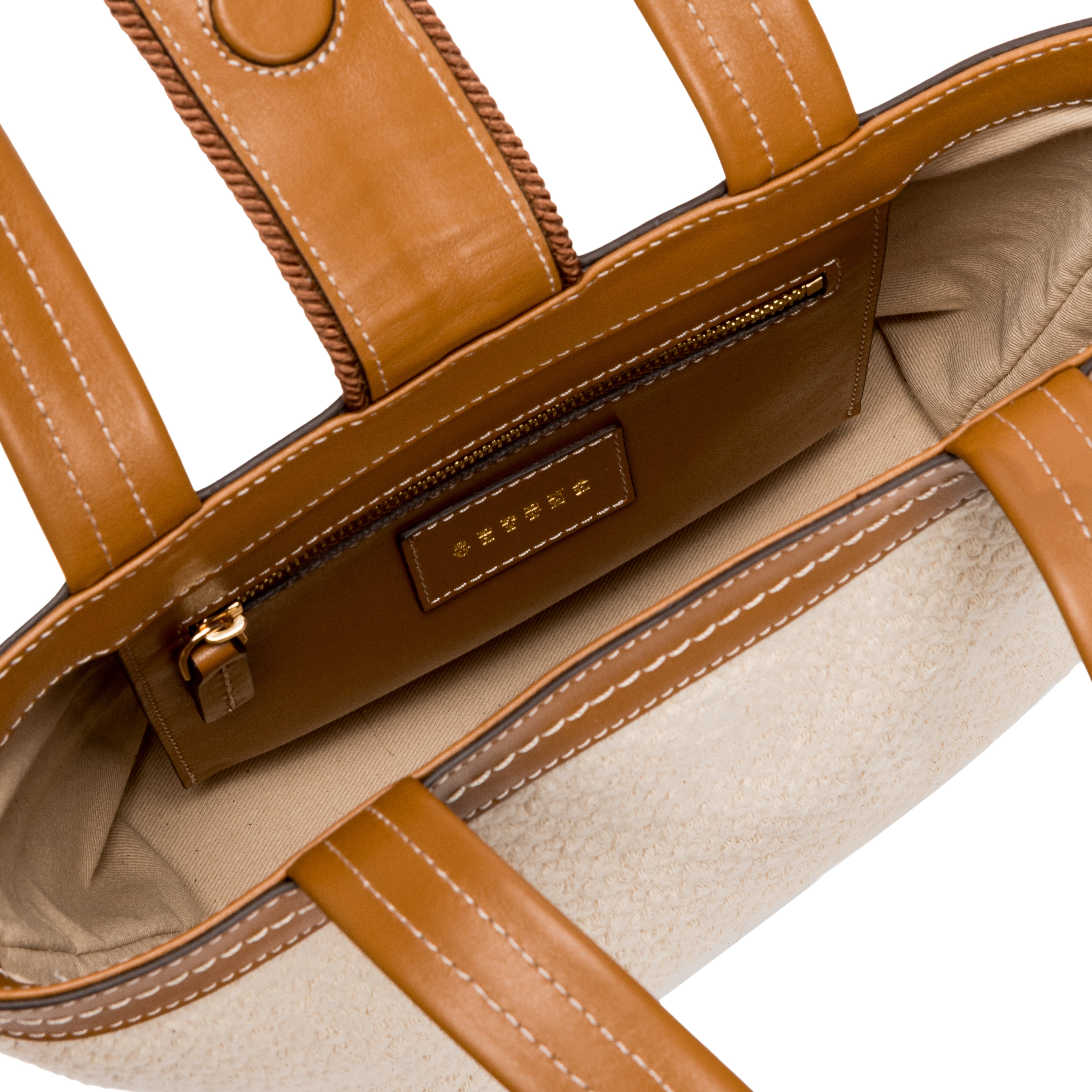 Interior view of a stylish boho chic small off-white tote bag showcasing organizational pockets and leather accents.
