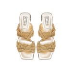 Rhea Gold 2 Knot Sandal featuring intricate knotted crochet straps and a comfortable block heel.