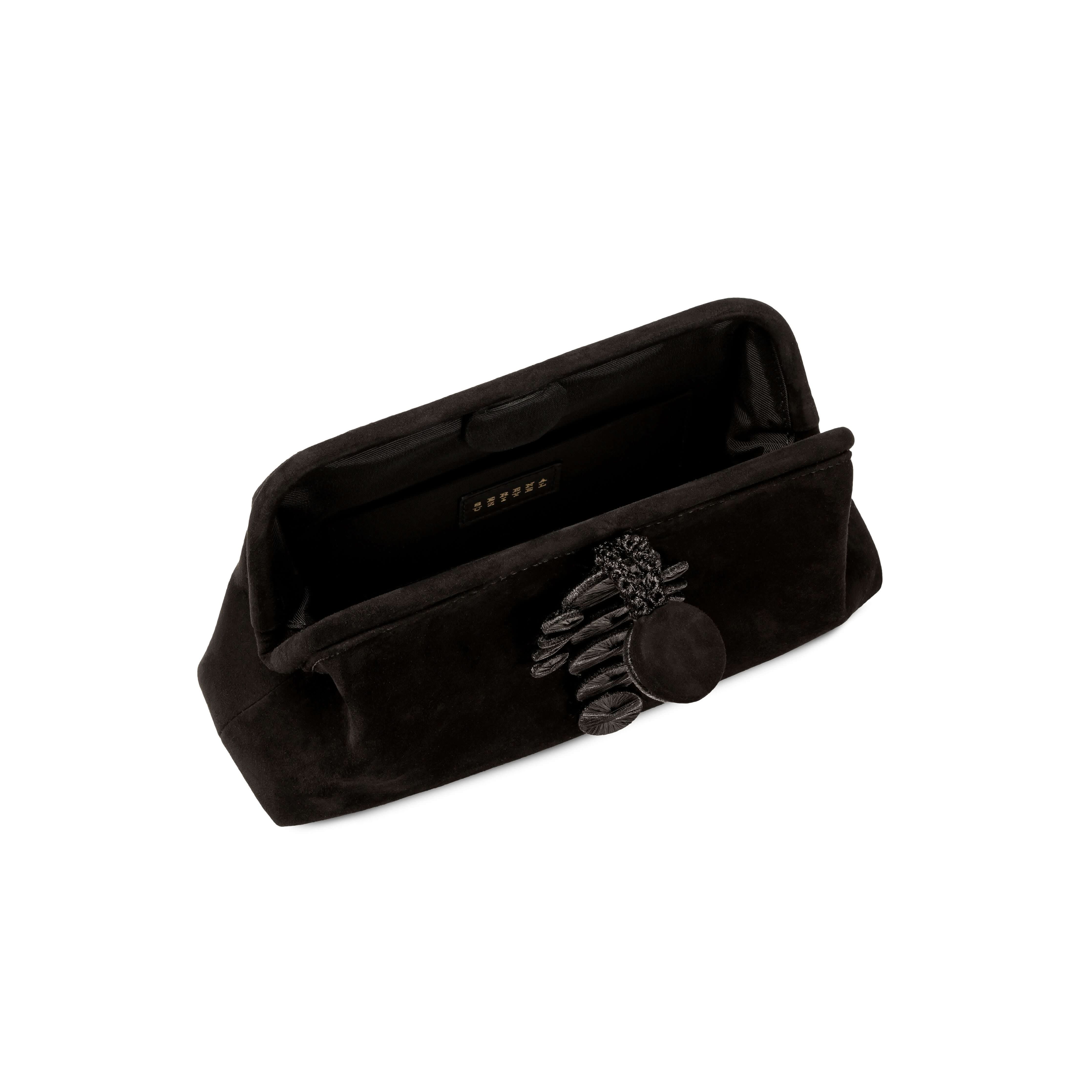 Alessa Black Pouch Bag interior view featuring a magnetic tab and decorative thread-wrapped coins.