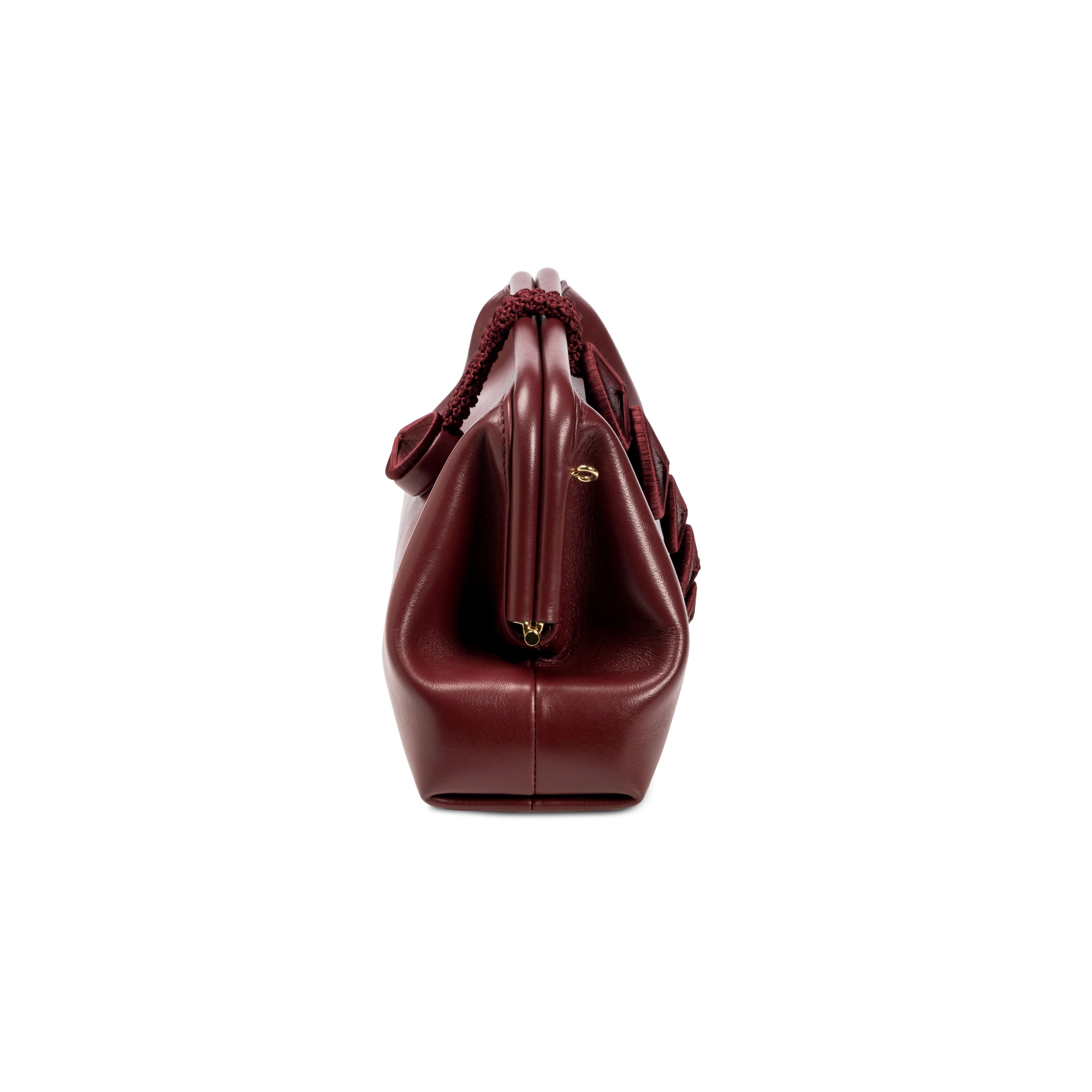 Alessa Burgundy Pouch Bag showcasing sleek design and high-quality materials, perfect for stylish outings.