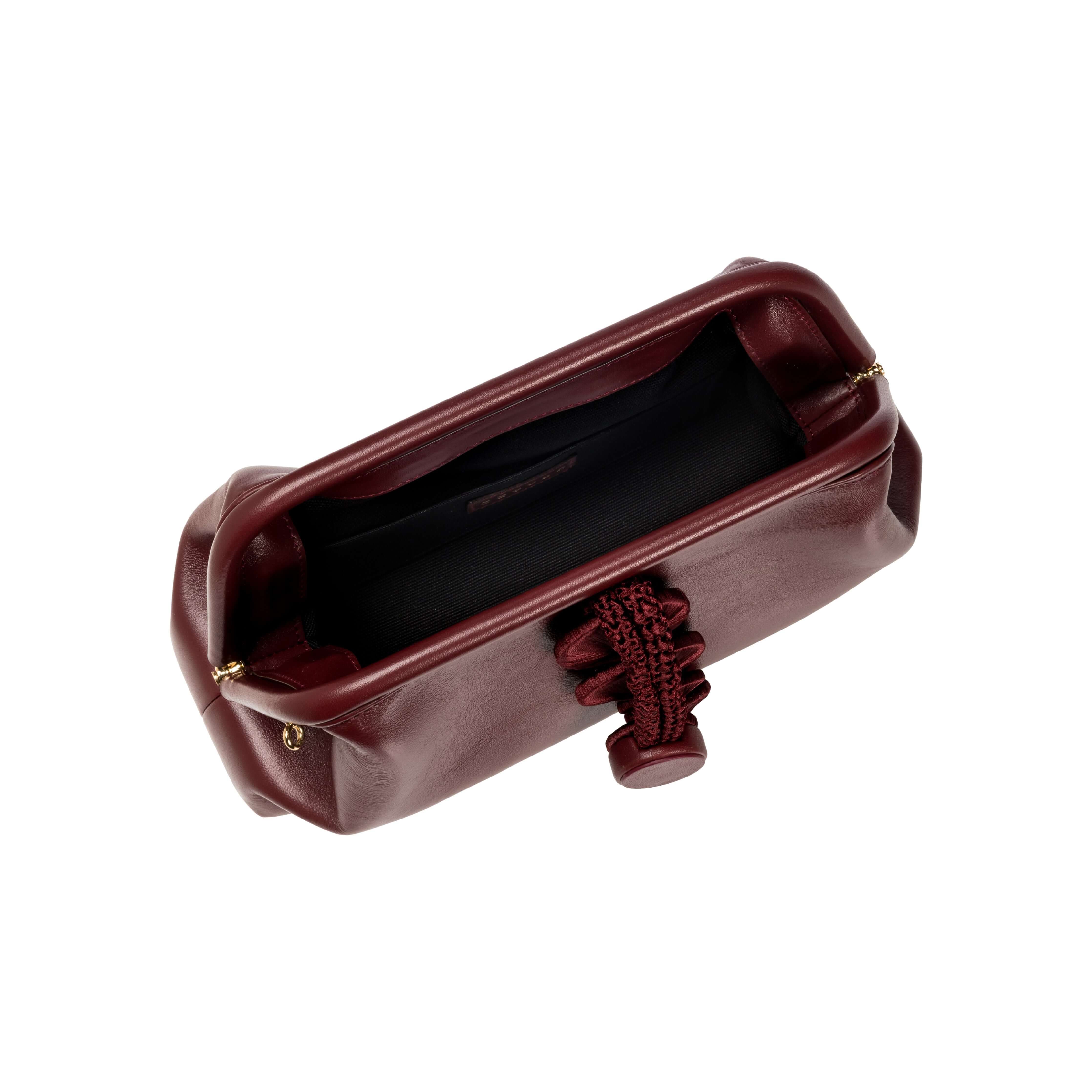 Alessa Burgundy Pouch Bag viewed from above, showcasing its rich burgundy color and stylish interior design.