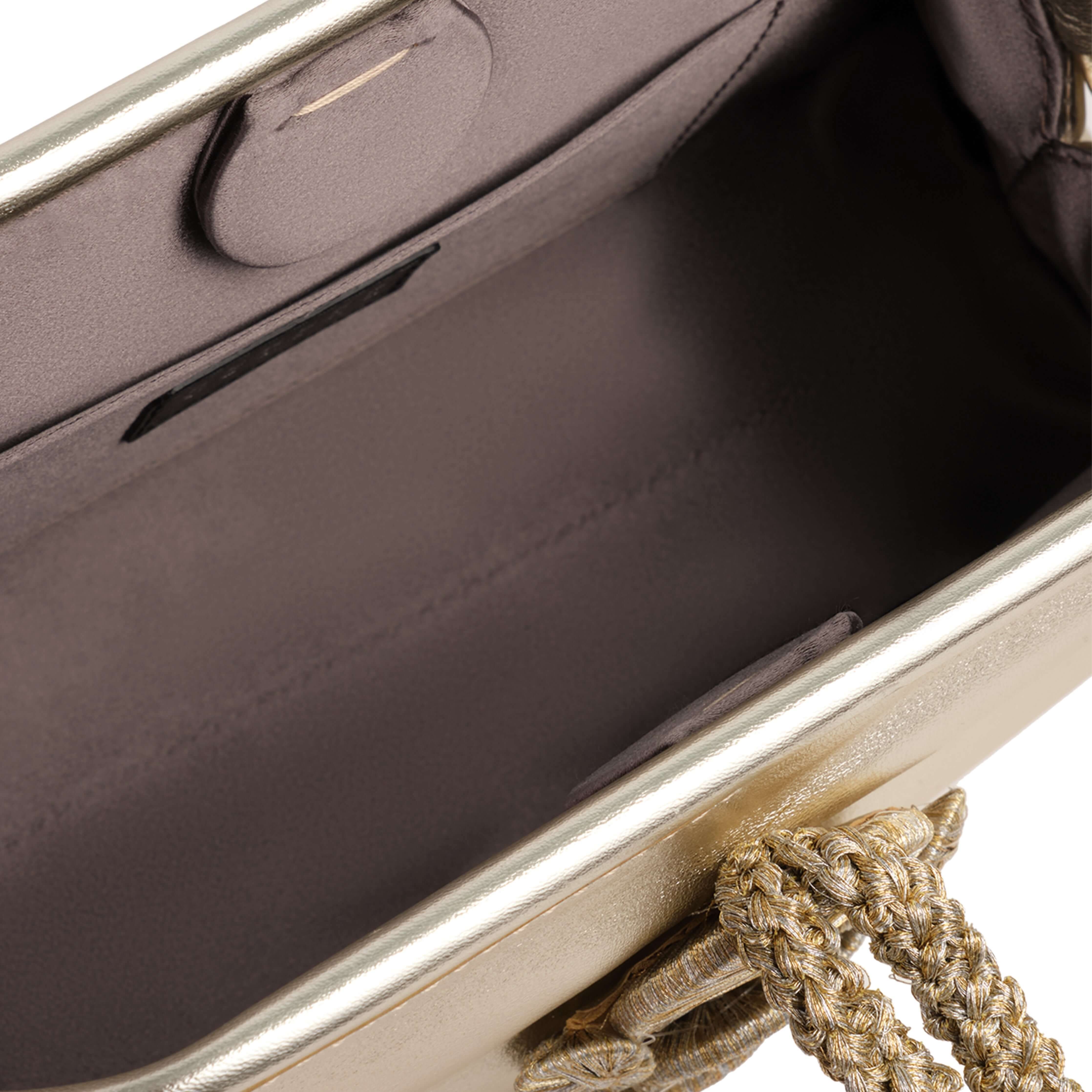 Interior view of the Alessa Sahara Pouch Bag showcasing its spacious compartment and elegant metallic lining.