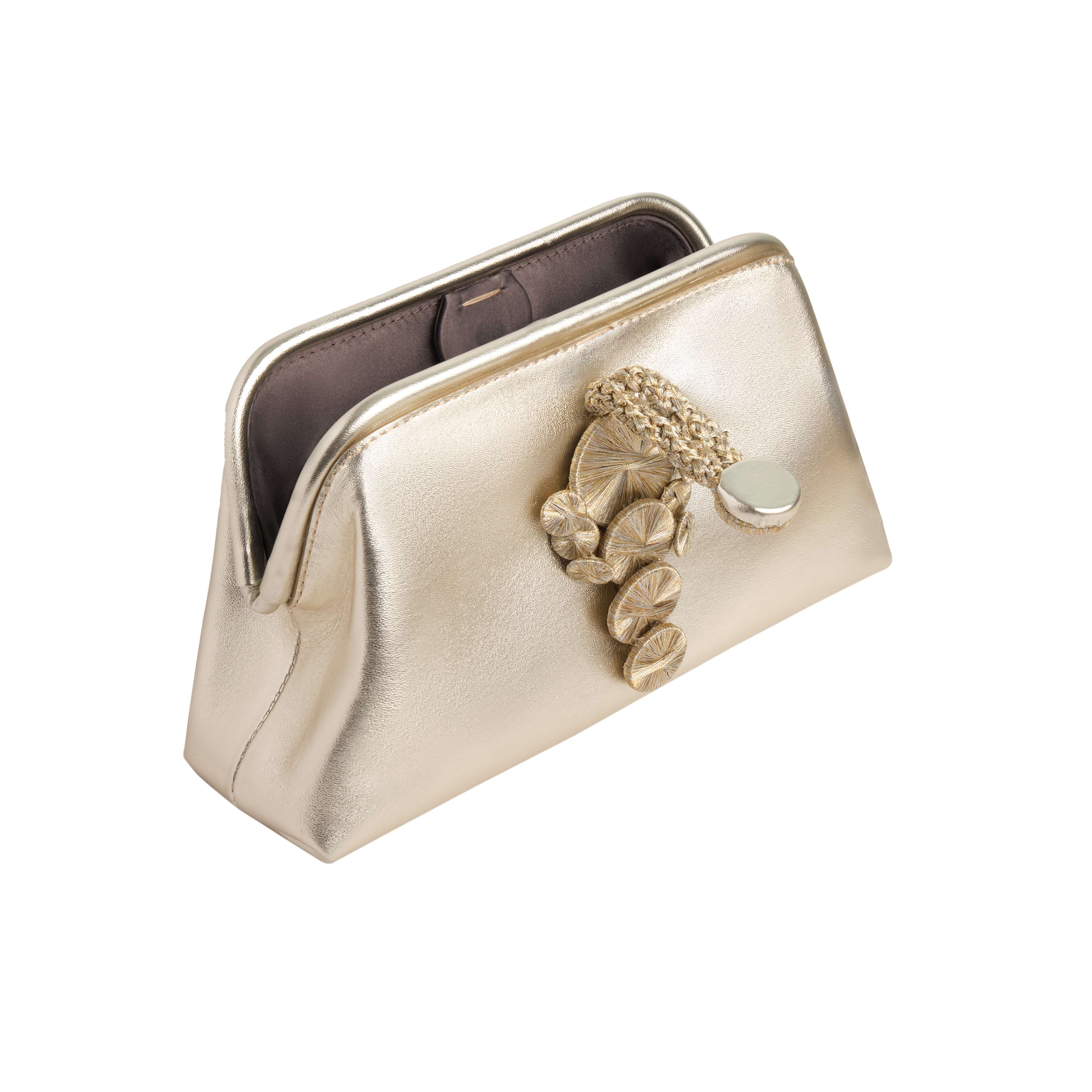 Alessa Sahara Pouch Bag in metallic gold with intricate thread-wrapped coin design and magnetic closure.