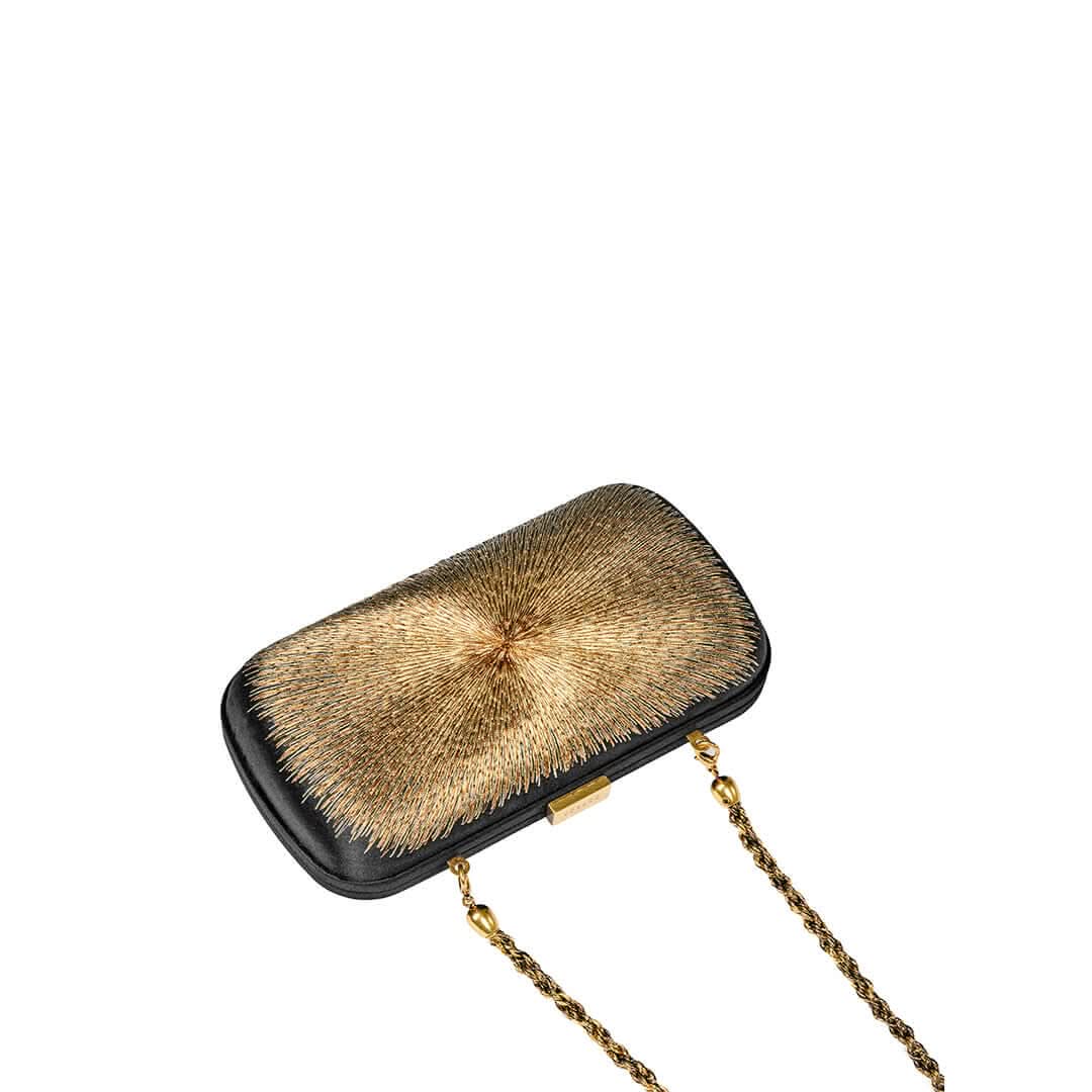 Arinna Black Clutch with intricate bronze and gold embroidery, evoking sun rays, crafted in sahara satin with chain strap.