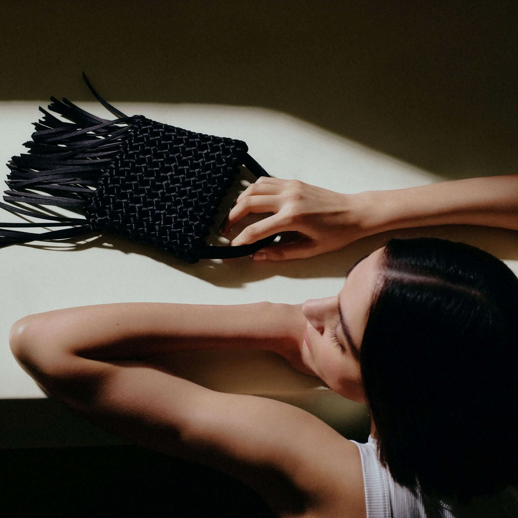 Aurnia Black Mini Tote Bag with leather and silk braiding, showcasing modern sophistication for day and night use.