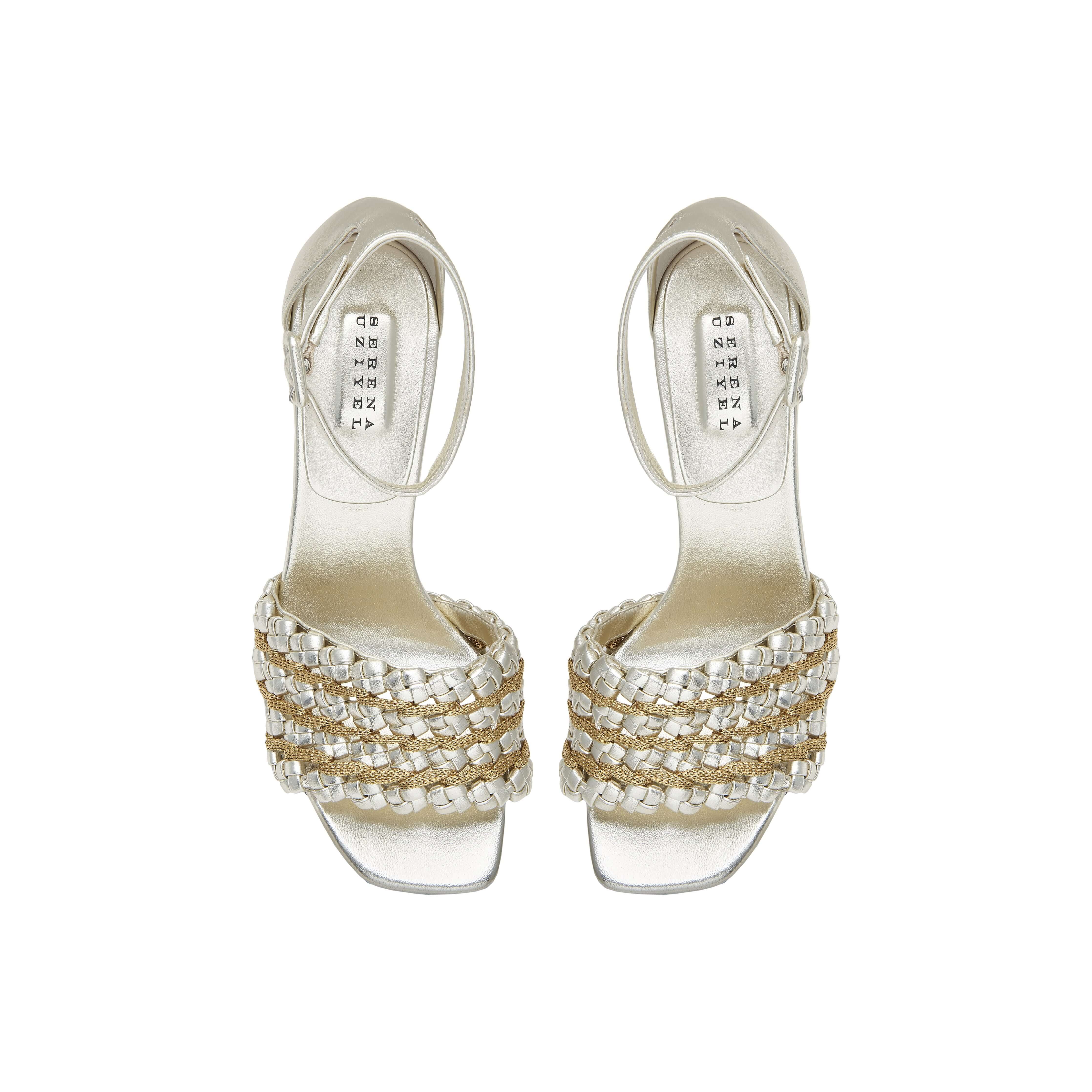 Elegant silver high-heeled sandals with unique braided design and ankle strap, perfect for formal occasions.