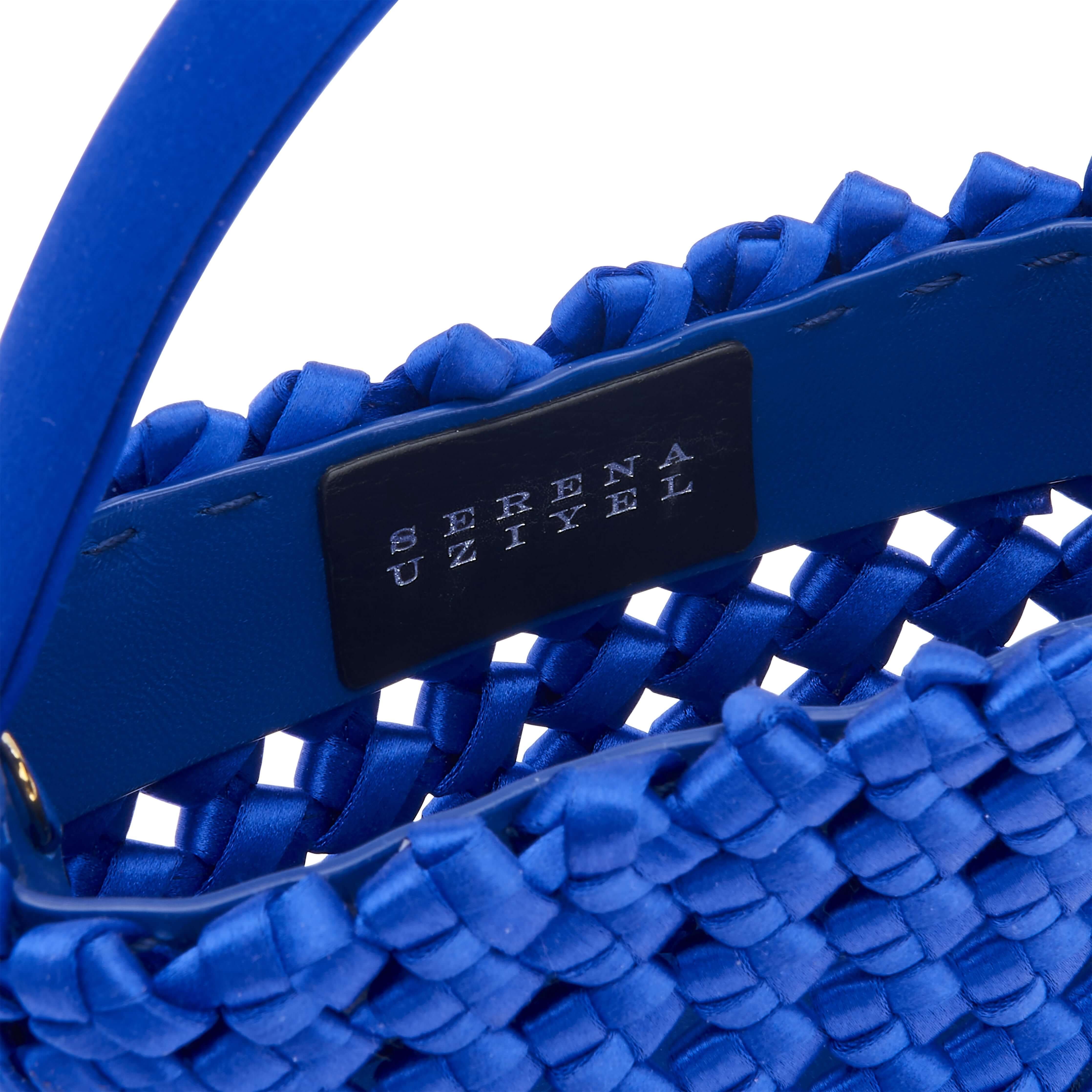 Close-up of Aurnia Mini Tote Bag's sapphire silk satin weave and Serena Uziyel branding.