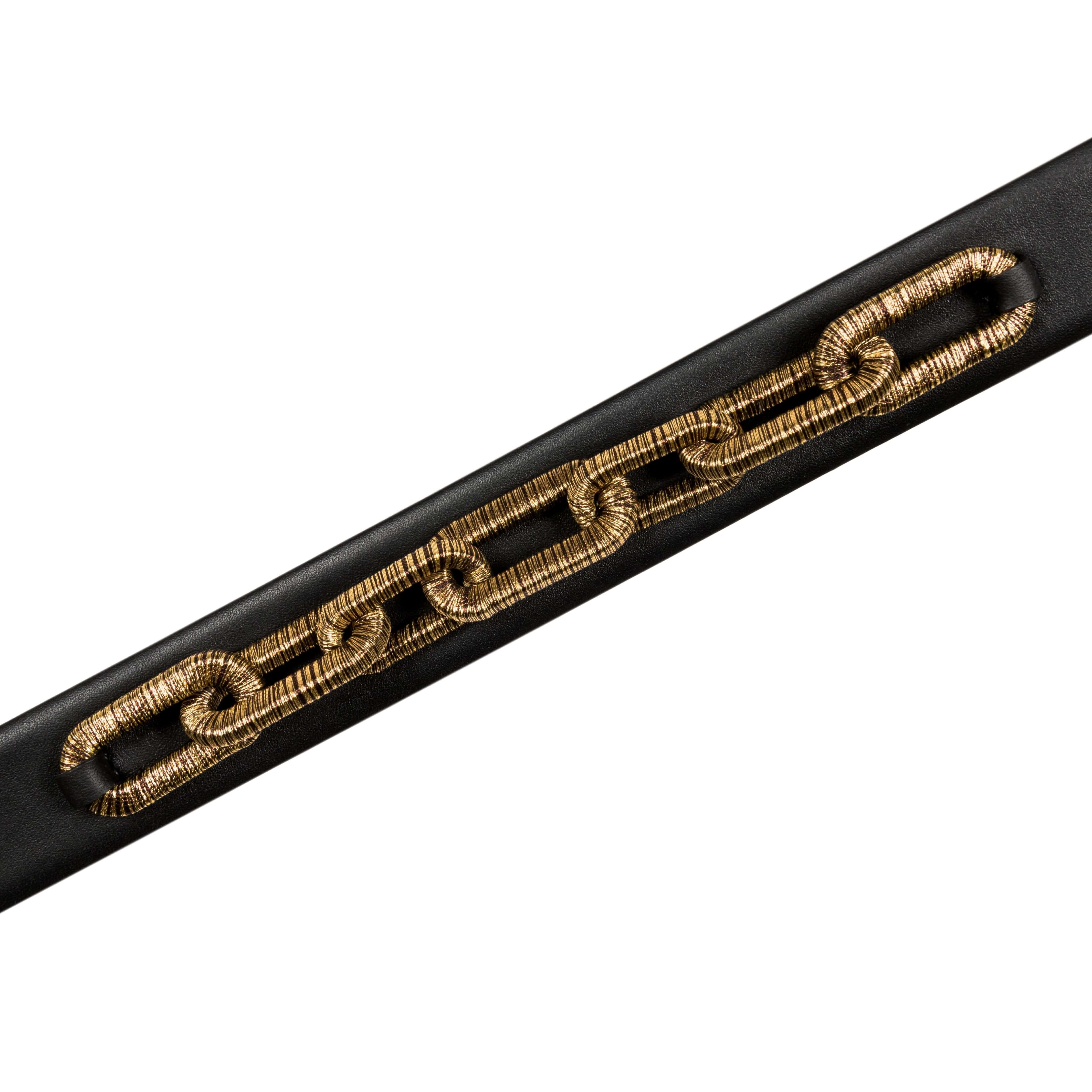 Catena Belt in black leather featuring antique gold chain detailing for a stylish accessory.