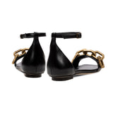 Catena Black Flat Ankle Sandal featuring a stylish metallic chain embellishment, showcasing elegance and comfort.