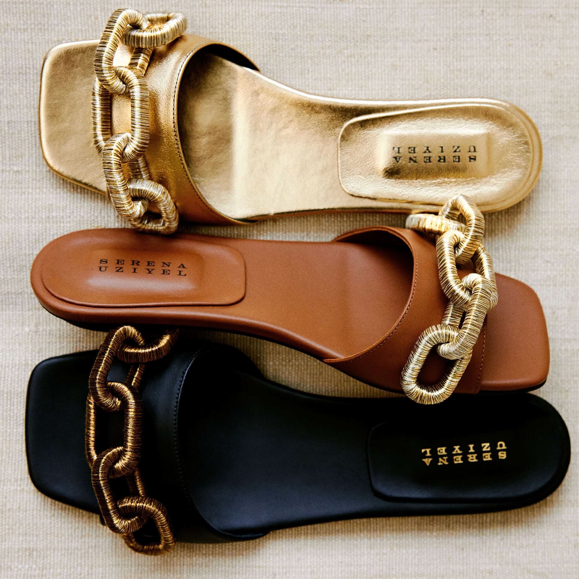 Catena Black Flat Sandal displayed with gold and brown variants, featuring chain embroidery in luxurious Italian leather.