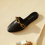 Catena Black Flat Sliperette in black leather with antique gold chain detail, stylish and feminine design.