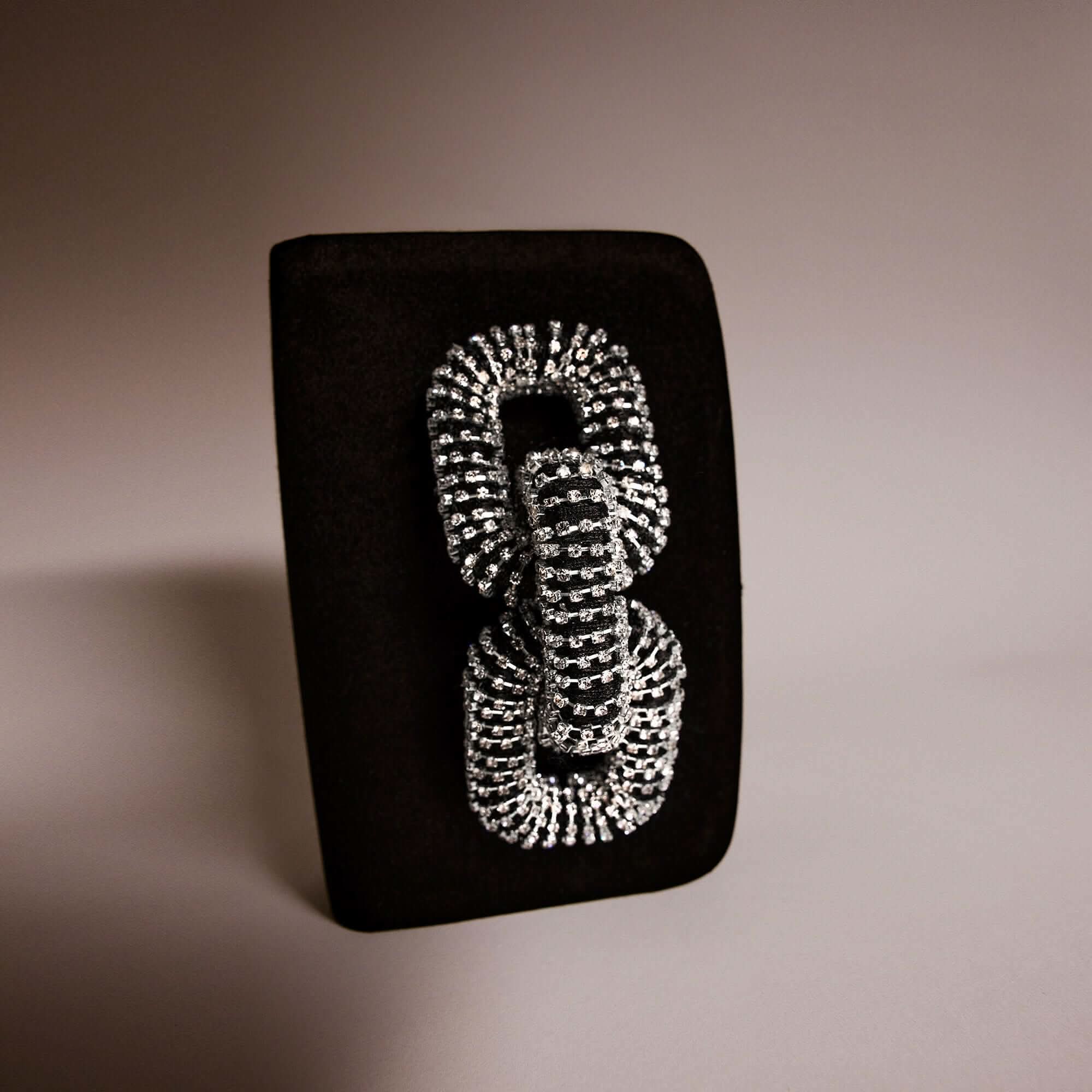 Elegant Catena Black & Glam Two Sided Clutch with intricate rhinestone detailing on a sleek black background.