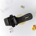 Top view of Catena Black Mid-Heel Sandal featuring chain link design on the toe strap, perfect for elegant occasions.