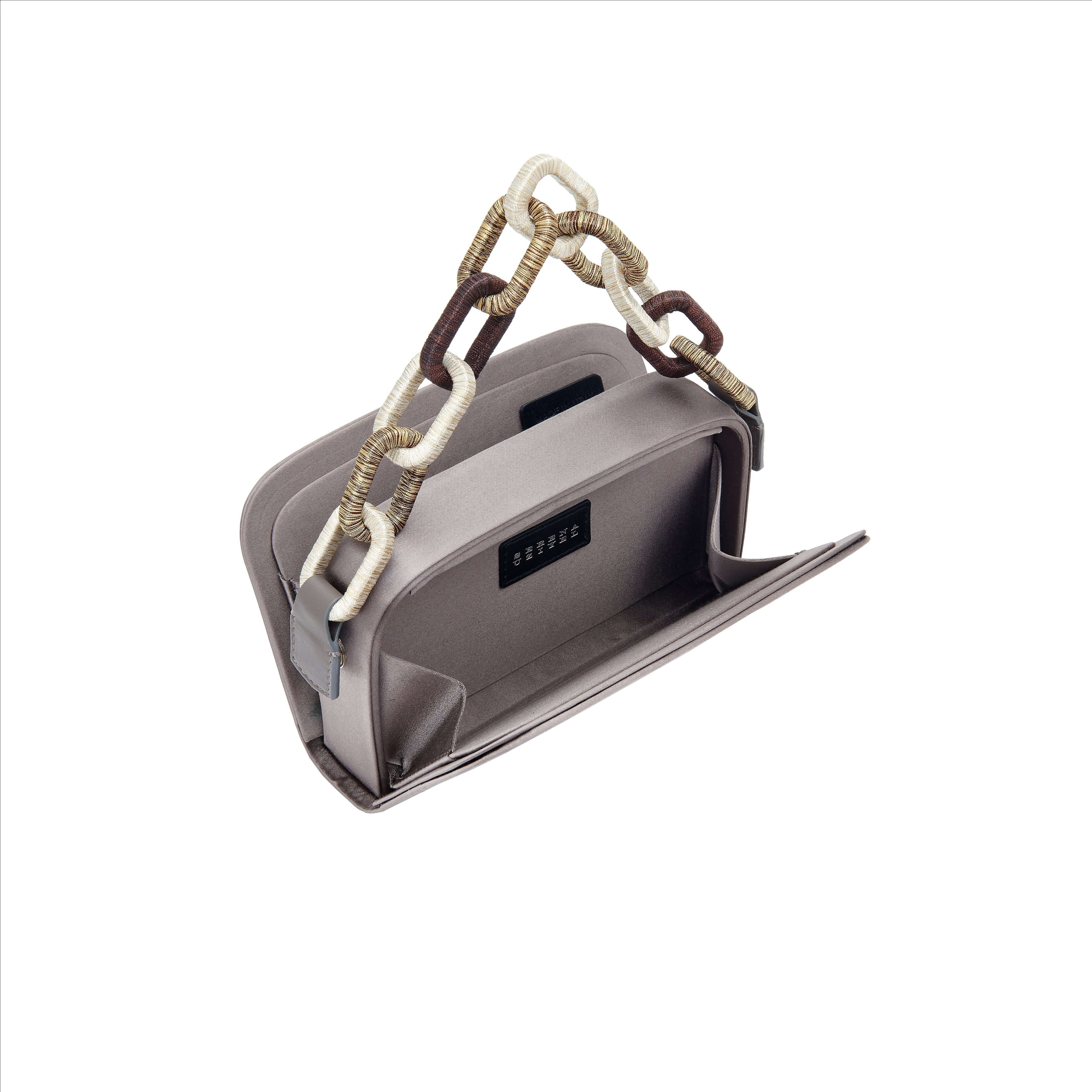 Luxurious Catena Electrum Two-Sided Bag in silk satin with unique chain-link handle and two independent compartments.