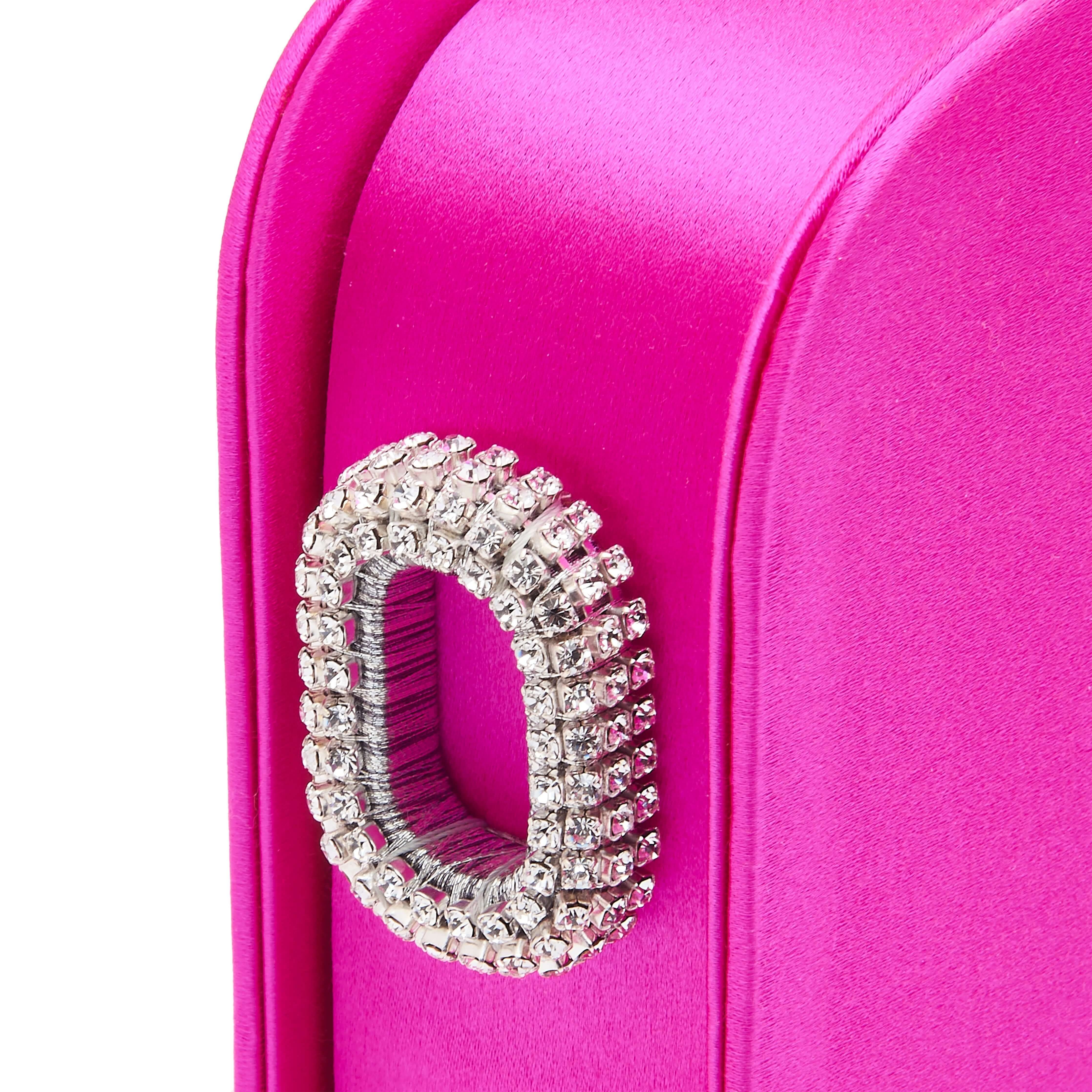 Close-up of the Catena Fuchsia Two Sided Clutch featuring a sparkling bijoux handle, highlighting modern craftsmanship.
