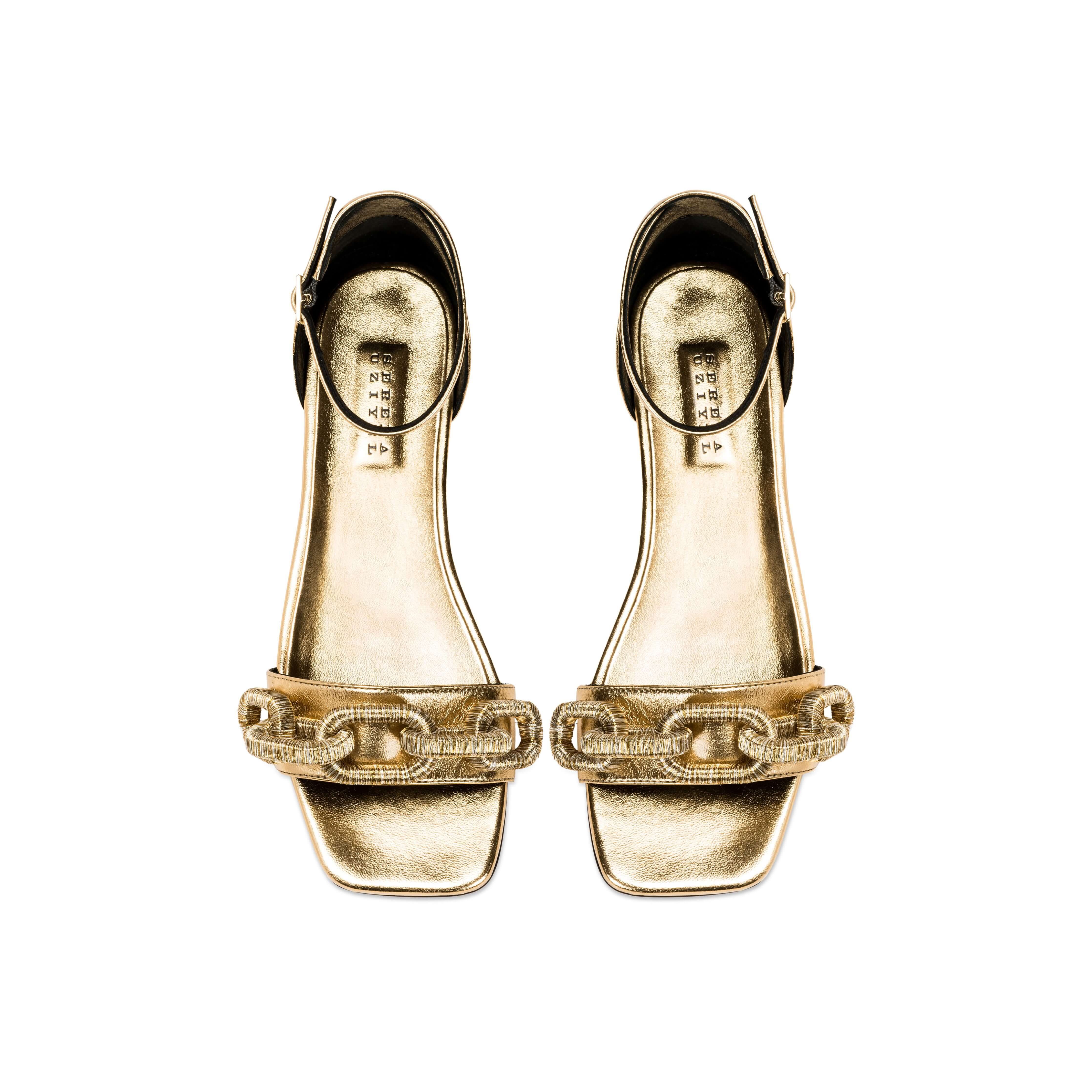 Elegant Catena gold flat ankle sandals featuring stylish straps and a sleek design, perfect for summer outings.