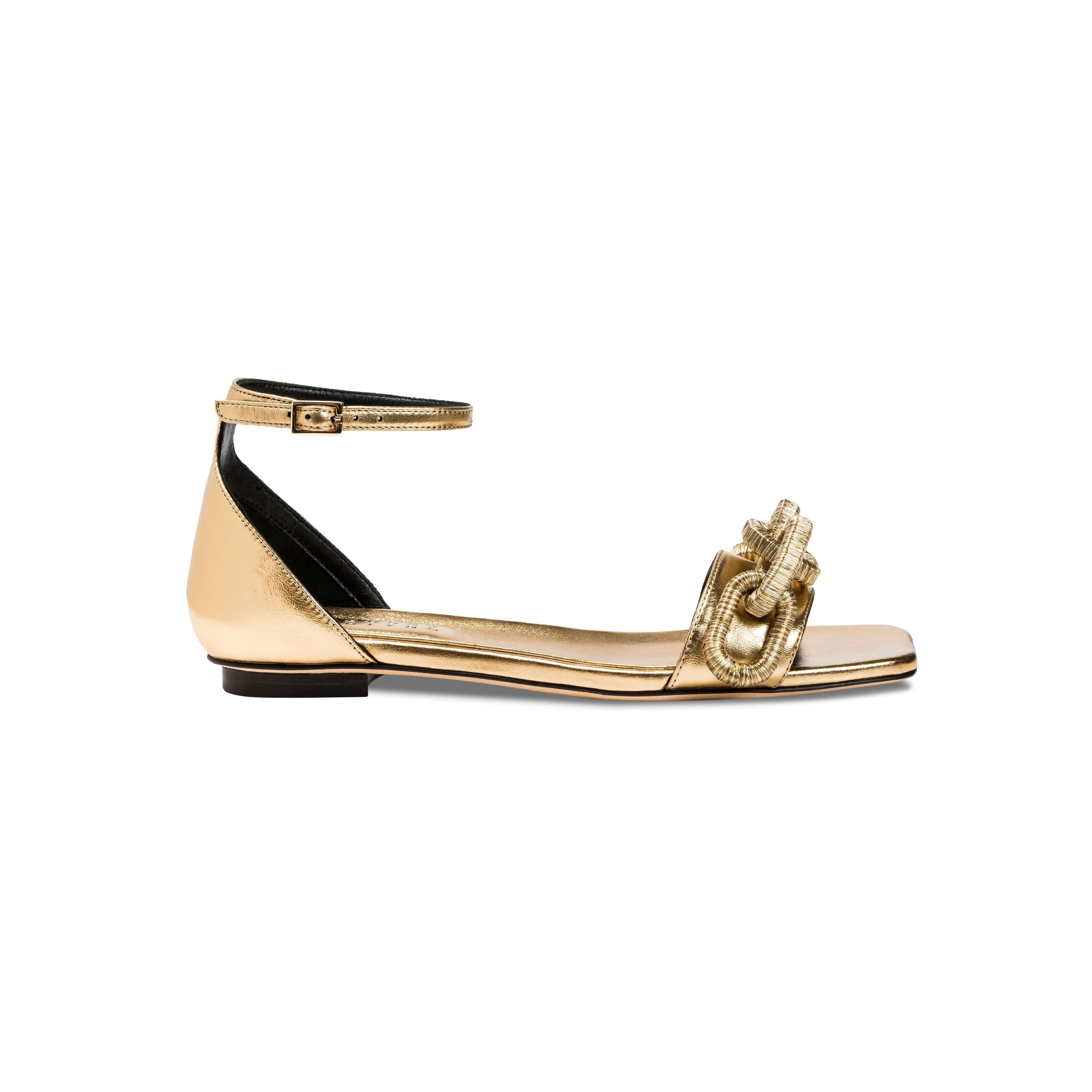 Catena Gold Flat Ankle Sandal showcasing a stylish design with a sophisticated metallic finish and ankle strap.