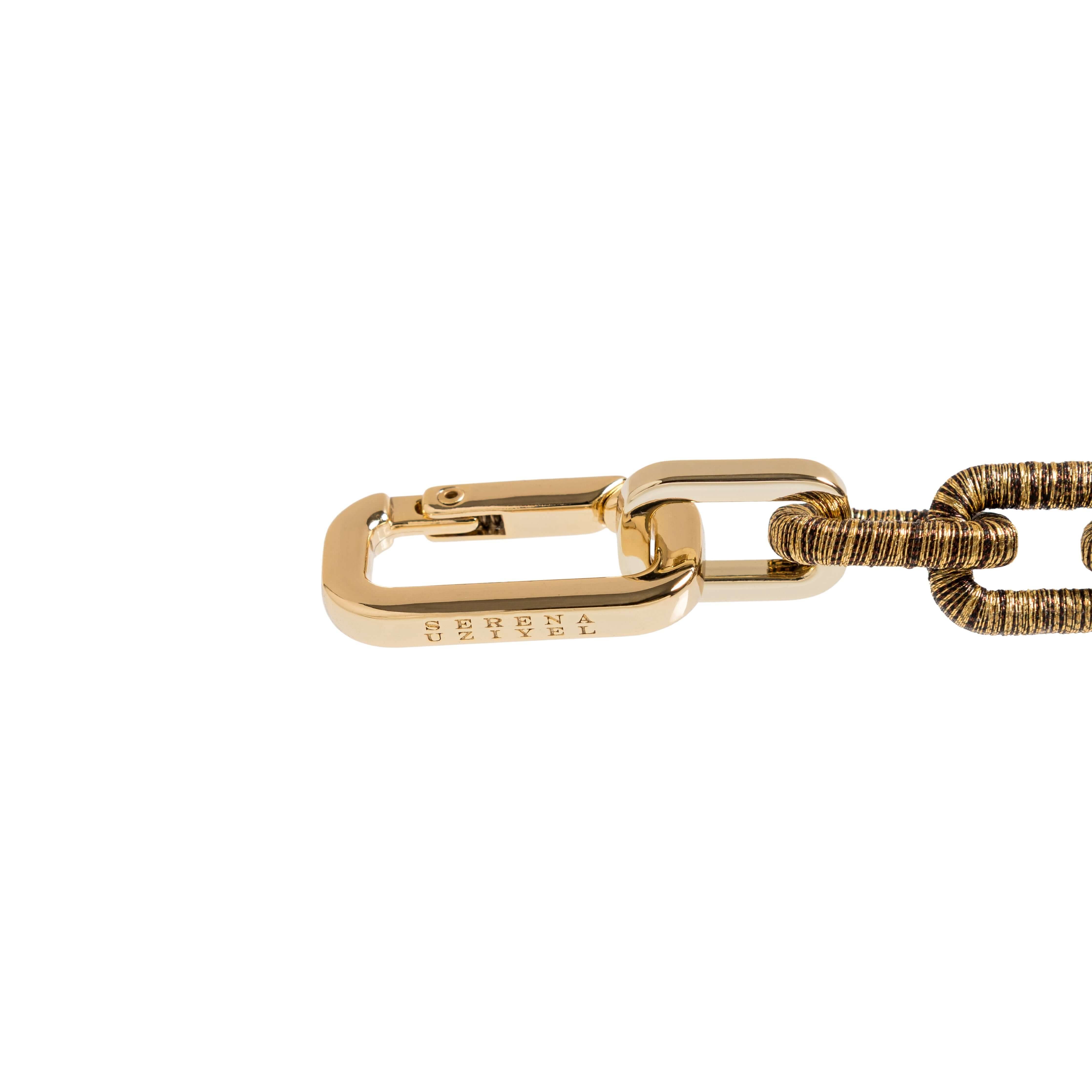 Close-up of the Catena Necklace in antique gold showcasing its stylish link design and unique texture.