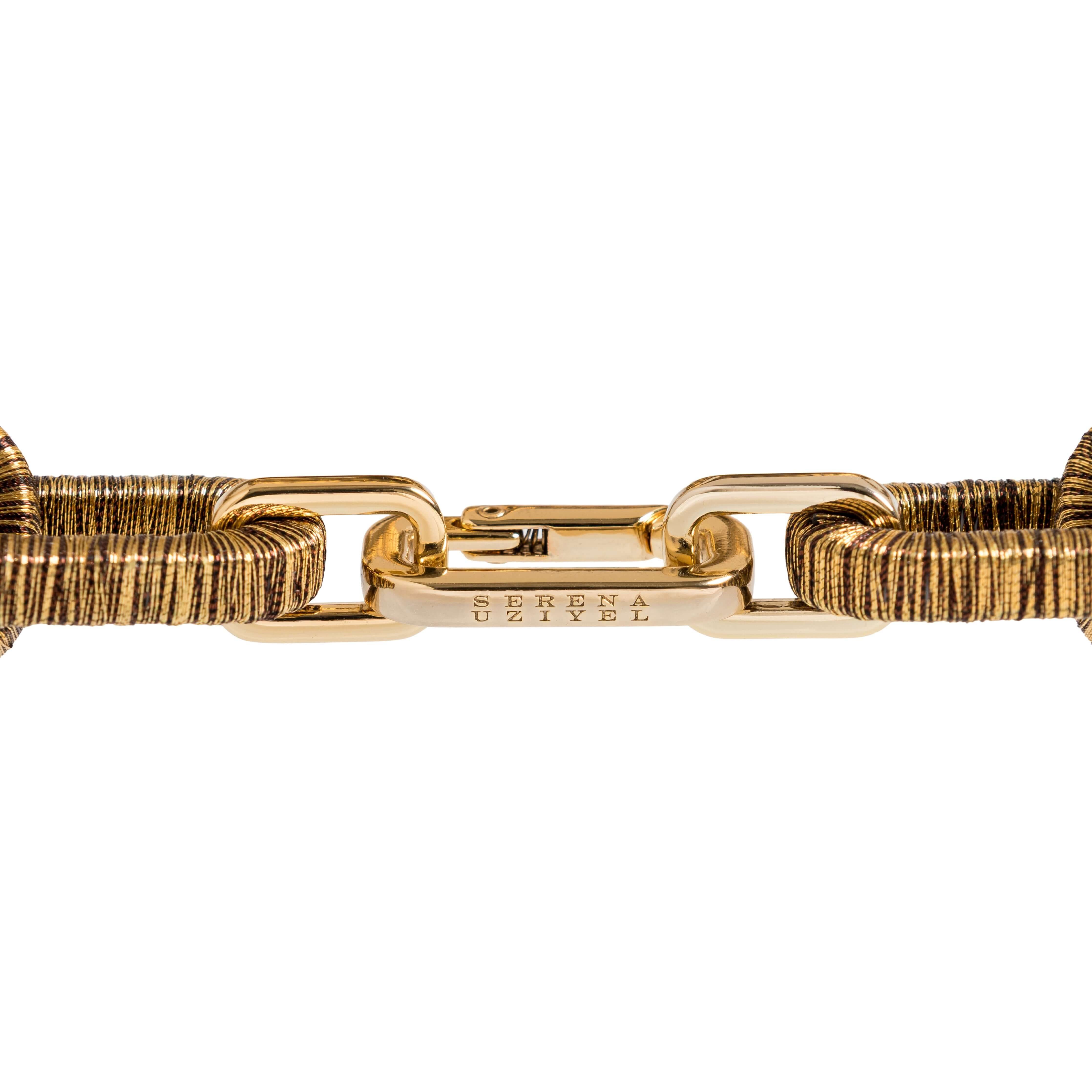 Detailed view of the Catena Necklace in antique gold, showcasing interlocking links and distinct texture.