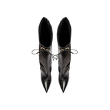 Top view of Catena Notte black high-heel knee boots with pointed toes and slouchy profile, featuring metallic drawstring.