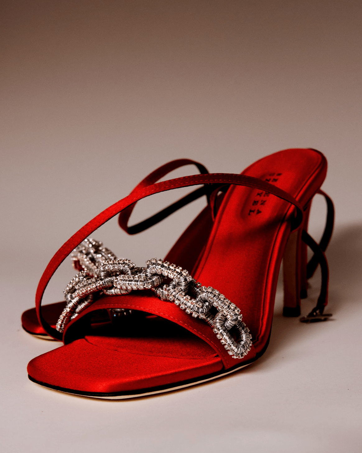 Catena Notte Scarlet & Glam high-heel ankle cross sandals in red silk satin with jeweled chain link detail.