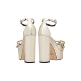Back view of Catena Sahara Platform Ankle Sandal in shimmering sahara-gold leather with chunky block heels.
