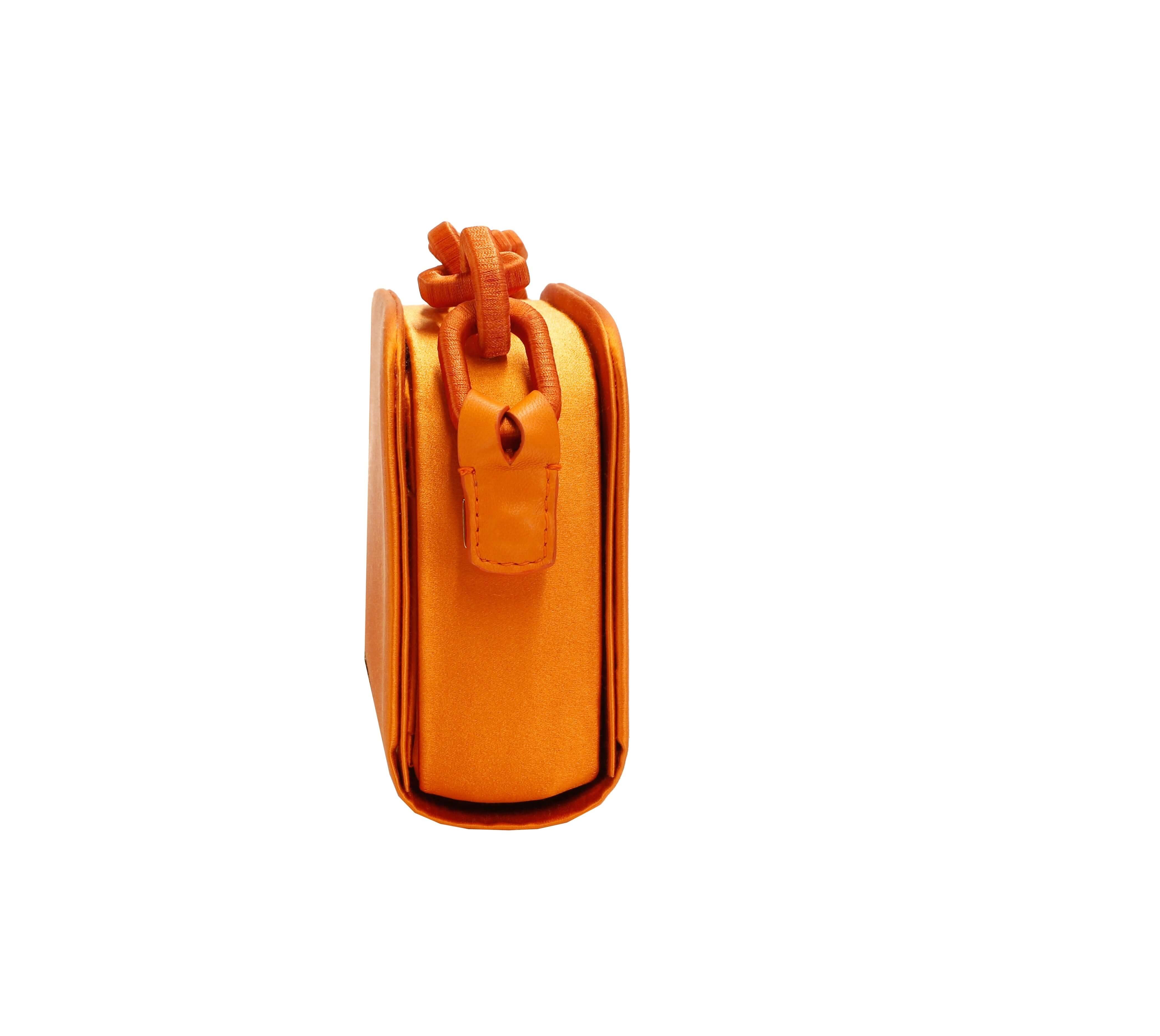 Catena Tangerine two-sided bag featuring a vibrant orange color and stylish design.