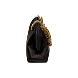 Fiora Black Pouch Bag featuring gold flower embellishment, perfect for elegant evening events.