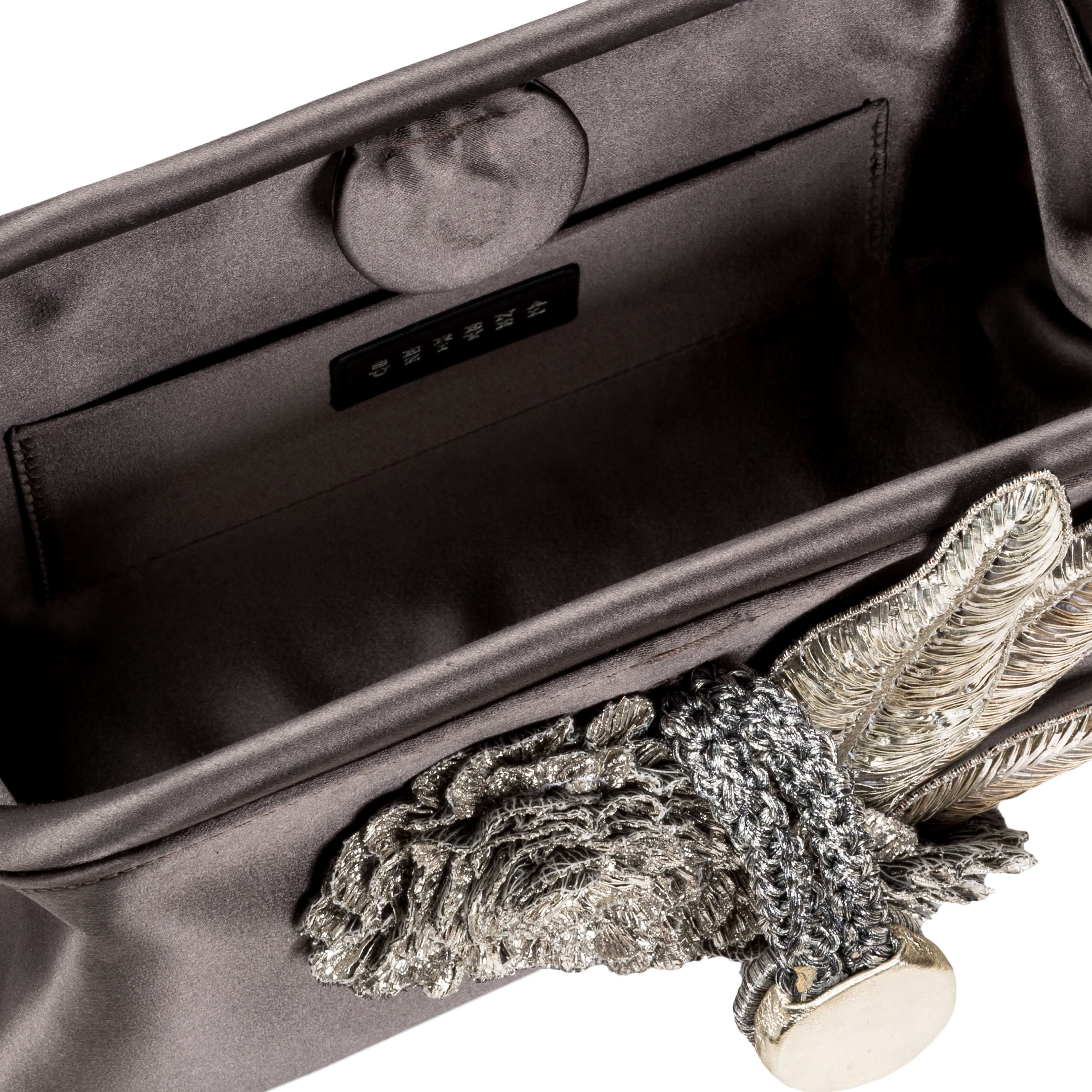 Interior view of the Fiora Electrum Pouch Bag showcasing elegant silver embellishments and luxurious fabric.