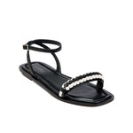 Kibele Black Ankle Cross Sandal featuring a chic design with an embellished strap perfect for summer outings.