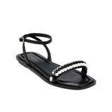 Kibele Black Ankle Cross Sandal featuring a chic design with an embellished strap perfect for summer outings.