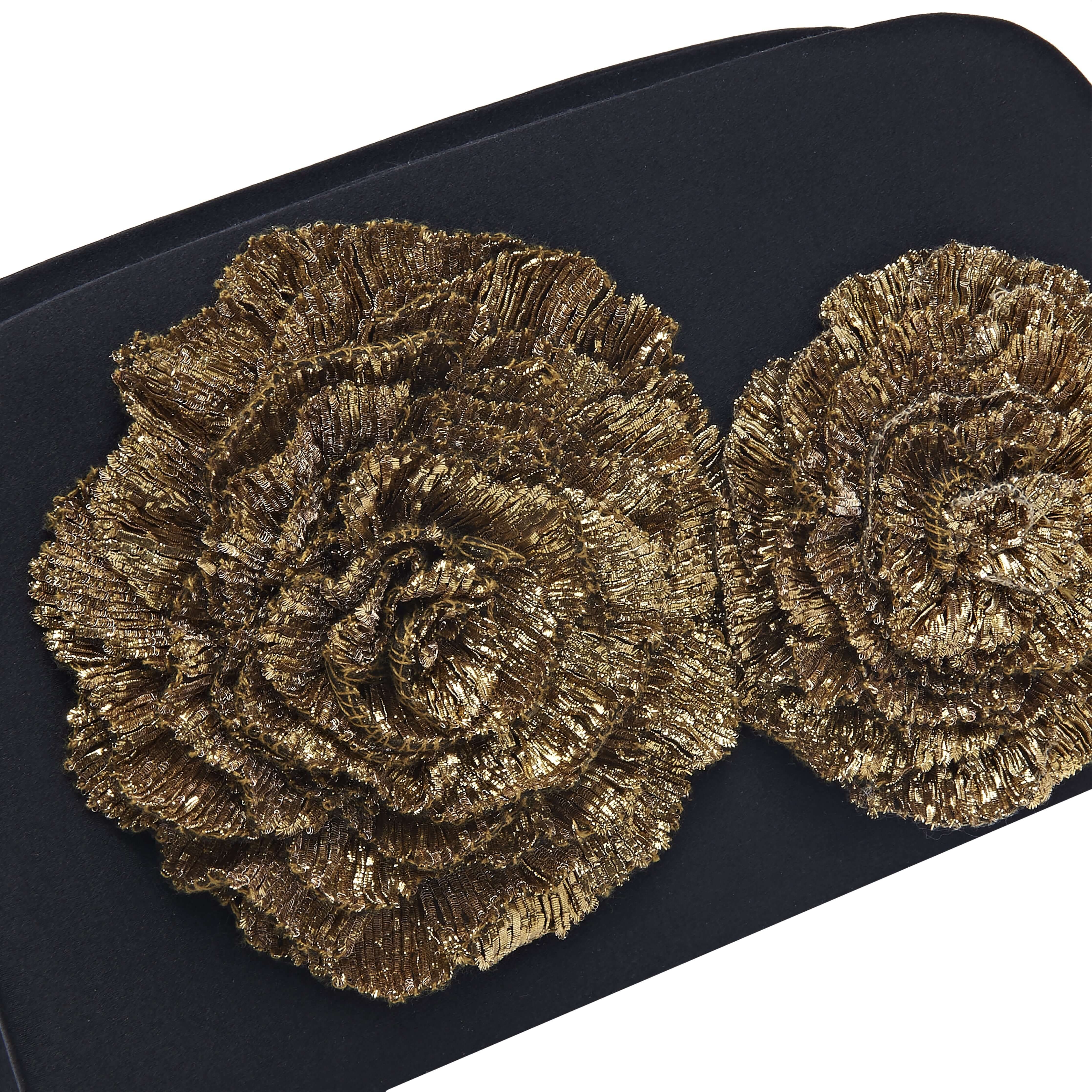 Close-up of gold Florette embellishments on a Lavinia Black Two-Sided Clutch, showcasing elegance and opulence.