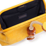 Interior view of the Petra Mustard Pouch Bag showcasing the soft suede material and unique wooden accents.