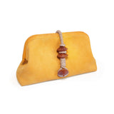 Petra Mustard Pouch Bag featuring a vibrant mustard color and decorative bead detailing.