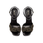 Rhea Black Ankle Cross Sandal featuring smooth leather and a crochet knotted front detail.