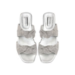 Rhea Silver 2 Knots Sandal featuring two intricately knotted crochet straps and a sleek metallic finish.