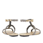 Back view of Ronda Gold Flat Gladiator Sandals featuring braided metallic straps and ankle buckle in antique gold.