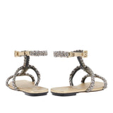 Back view of Ronda Gold Flat Gladiator Sandals featuring braided metallic straps and ankle buckle in antique gold.