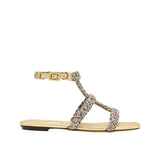 Ronda Gold Flat Gladiator Sandal featuring multi-colored woven metallic straps for a luxurious summer style.