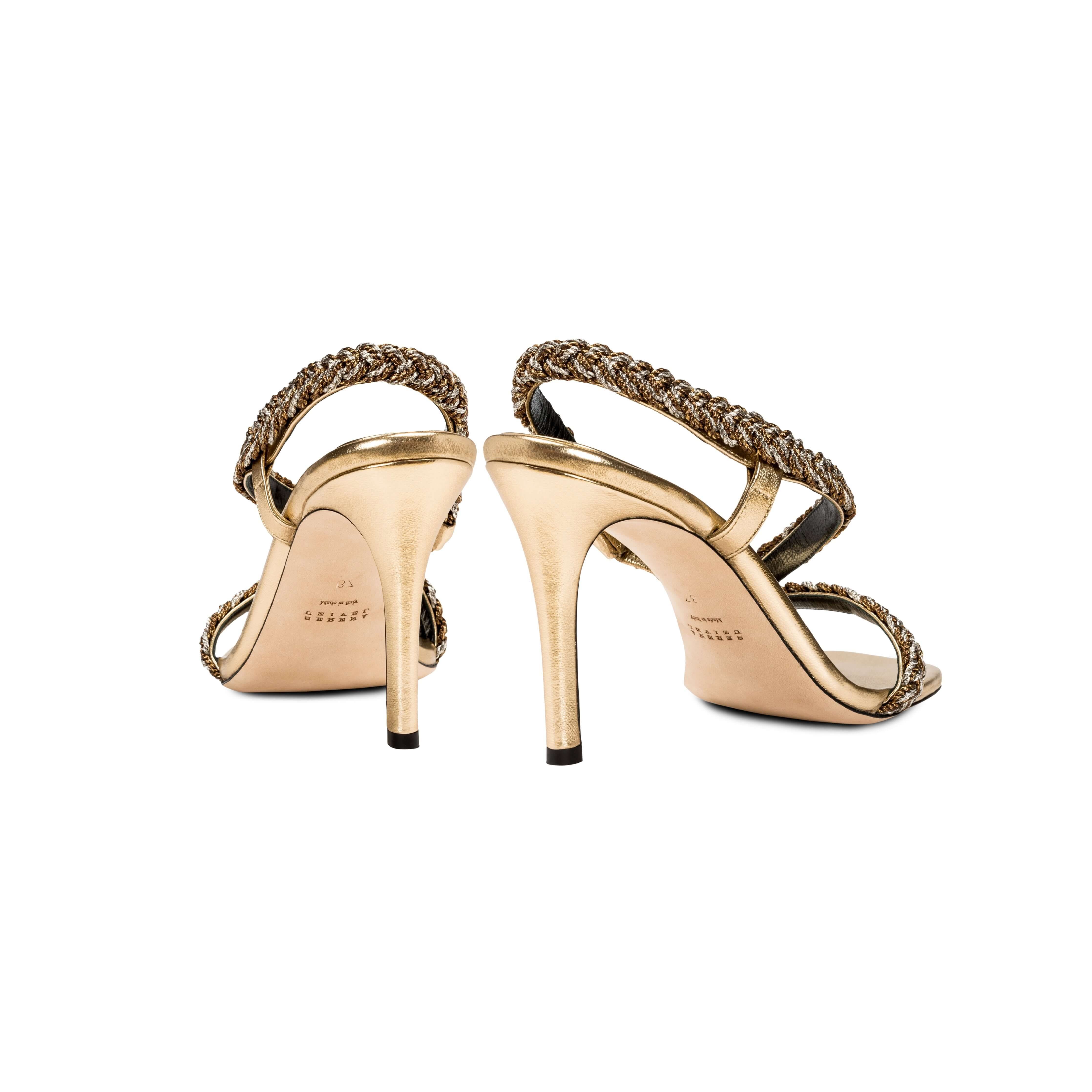 Ronda Gold High-Heel Asymmetric Sandal featuring braided straps and elegant stiletto heel.