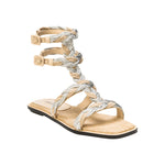 Ronda Natural Flat Gladiator Sandal featuring braided straps and adjustable buckles for stylish summer comfort.
