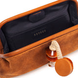 Interior view of the Petra Camello Pouch Bag featuring suede leather and a unique stone embroidered detail.