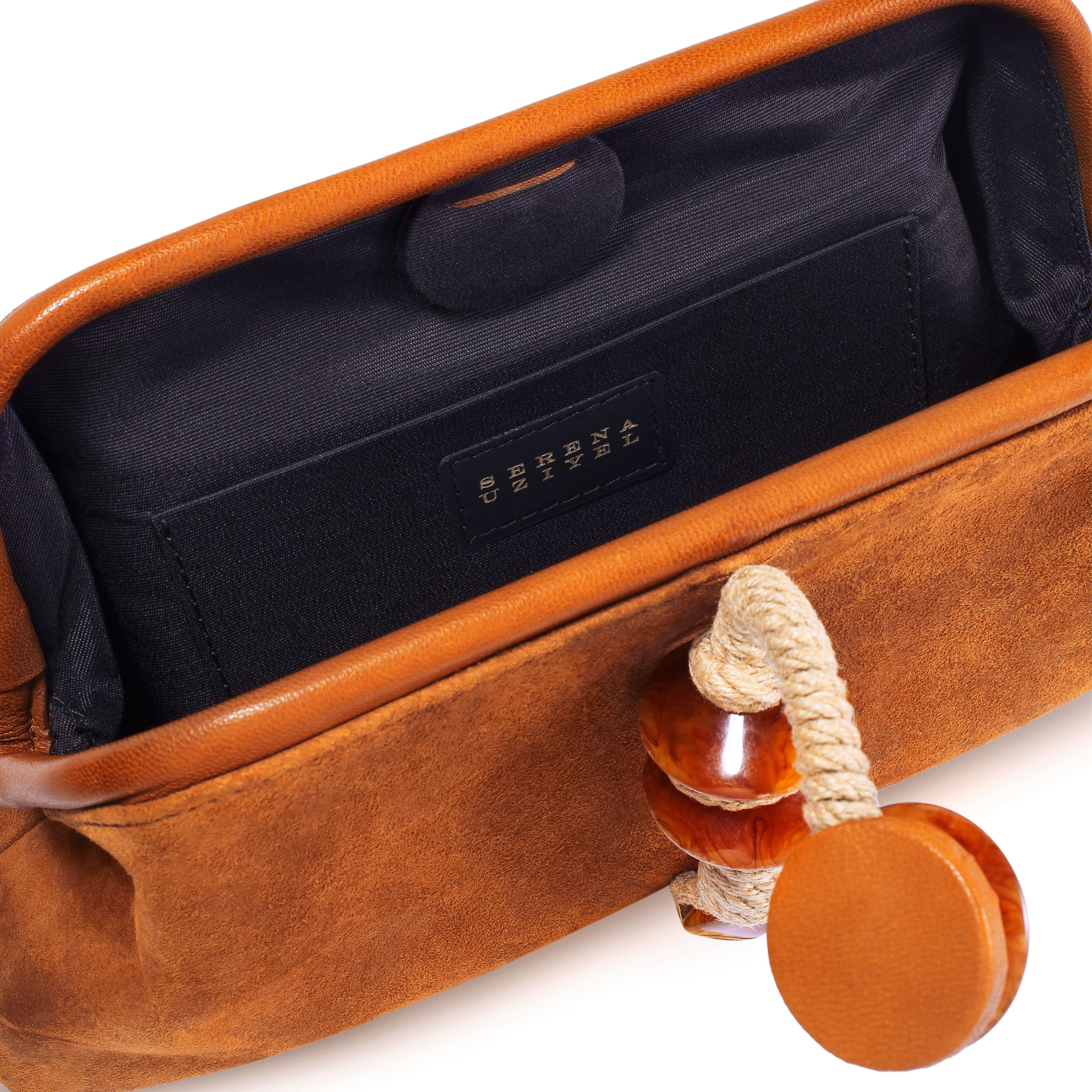 Interior view of the Petra Camello Pouch Bag featuring suede leather and a unique stone embroidered detail.