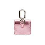 Sculptural metallic pink AirPods case with silver carabiner, handcrafted in Italy for stylish functionality.