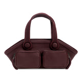 Burgundy handbag with two square compartments on a white background