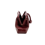Alessa Burgundy Pouch Bag showcasing its unique design and elegant shape, perfect for stylish outings.
