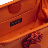 Interior view of Alessa Tangerine Pouch Bag, showcasing silk-satin fabric and intricate knotted coin design.