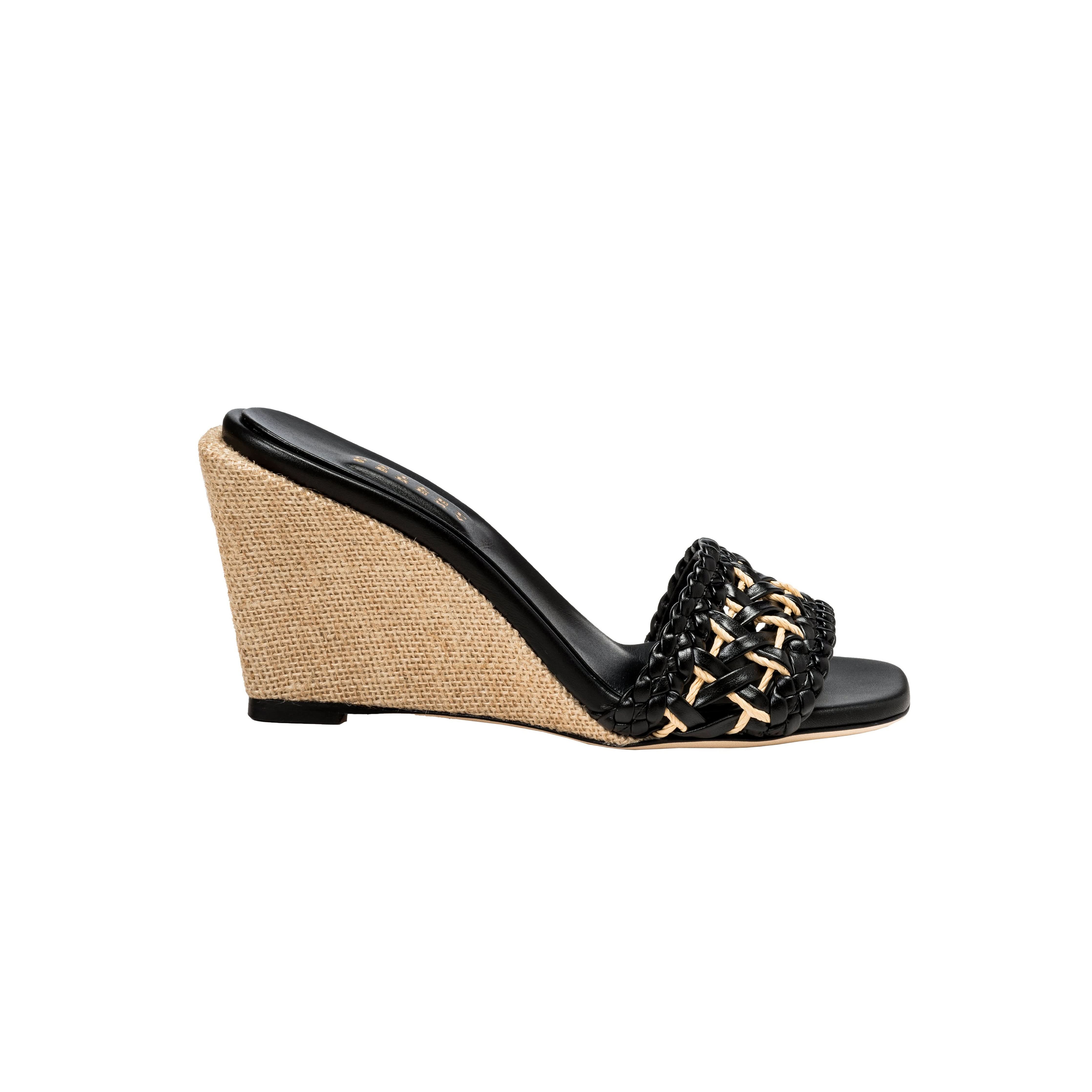 Almeria black wedge sandal showcasing a stylish woven strap and natural woven wedge heel, perfect for summer fashion.
